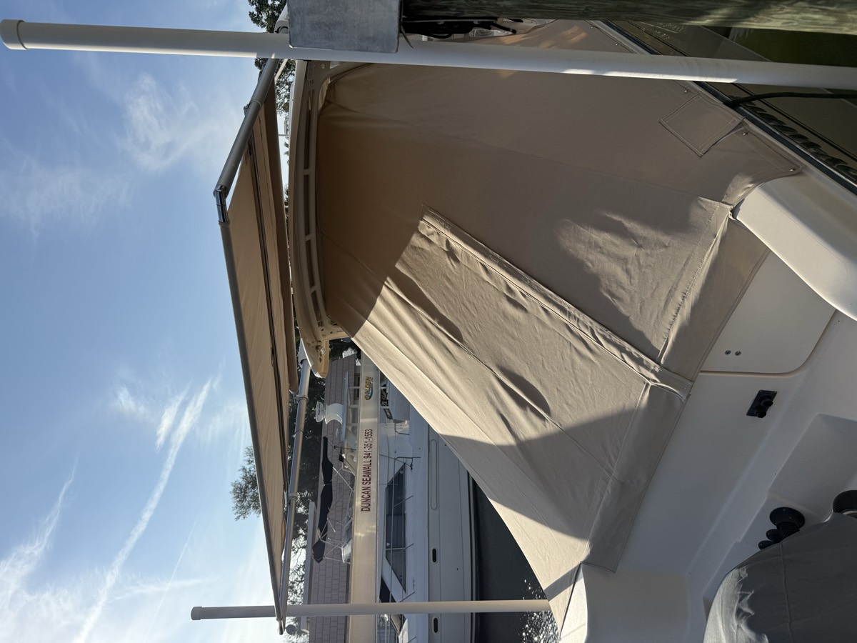 Custom canvas enclosure and awning fitted to the cockpit of a cruiser