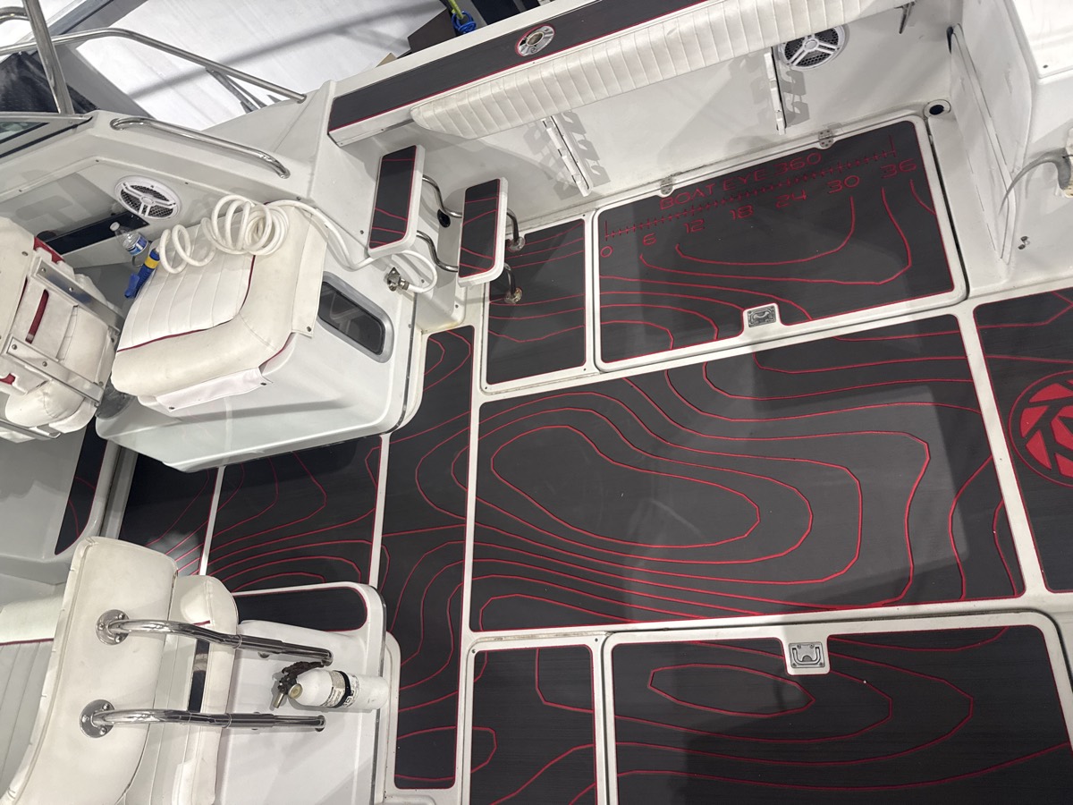 Black and red custom marine decking across a full center console cockpit