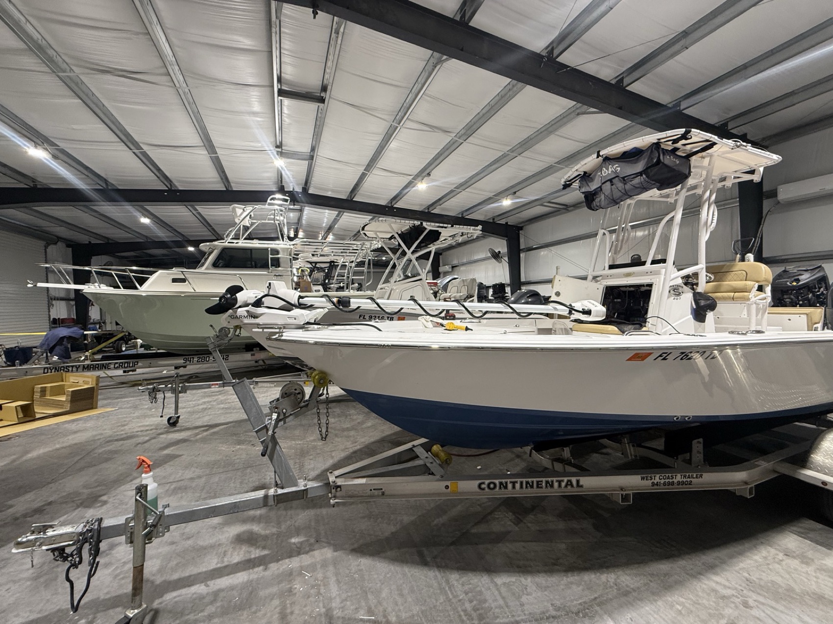 Boats in for service inside the Dynasty Marine Customs shop bay